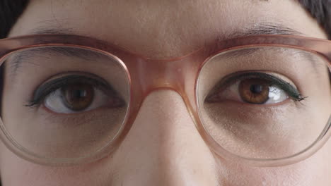 close up young woman brown eyes opening looking at camera wearing stylish glasses eye care concept