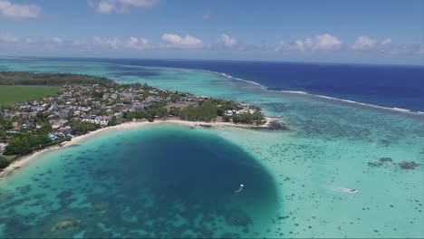 islands of the republic of mauritius with crystal clear blue waters on the coastline and motor boat speeding on a vacation