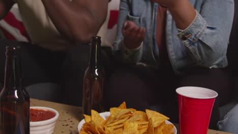 Close-Up-Of-People-Celebrating-At-Party-For-American-Independence-Day-4th-July-Eating-Snacks-Chips-And-Dips