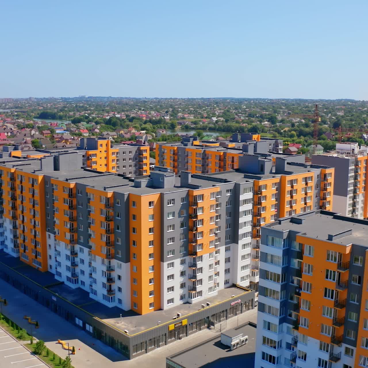 Modern residential apartment complex. High rise buildings with bright colorful facade. Concept of accommodation and urbanization. Aerial view