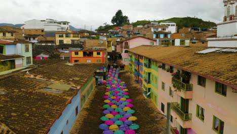 establishing aerial shot of city street with colorful umbrellas in south america