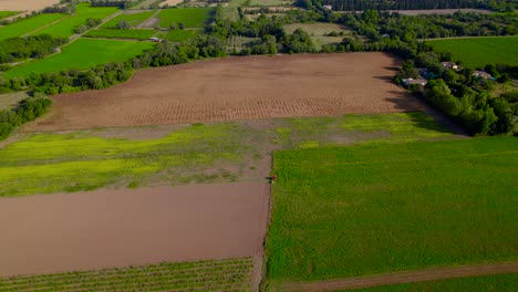 Aerial-view-of-varied-farmland-and-town-in-Bernis,-France