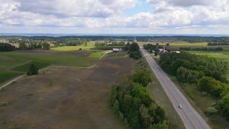 green countryside landscape and road in michigan, aerial view