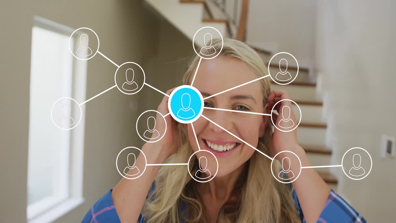 Smiling woman with network of connections animation over her in home setting