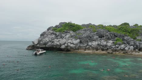 tourist snorkeling in tropical water at koh wao island in ang thong marine park