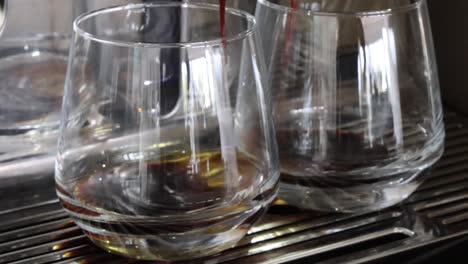 espresso being poured into two glasses