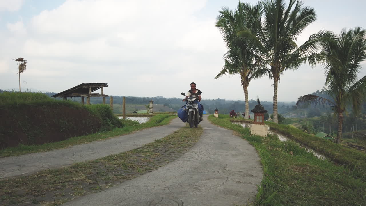 Vehicles on a Rural Road through Tropical Landscape