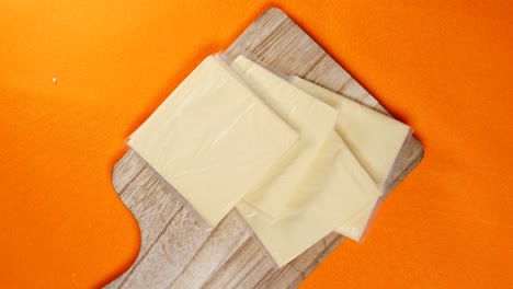 cheese slices on a wooden board