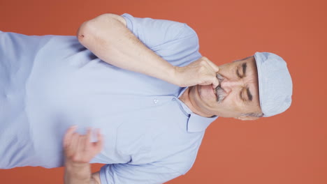 Vertical-video-of-The-old-man-is-biting-his-nails.