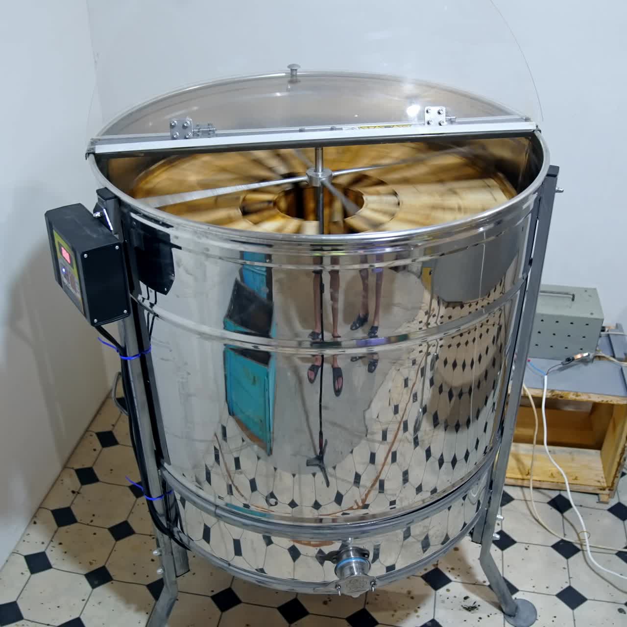 Honey extractor at beefarm. Honey extractor spinning with frames with honeycombs