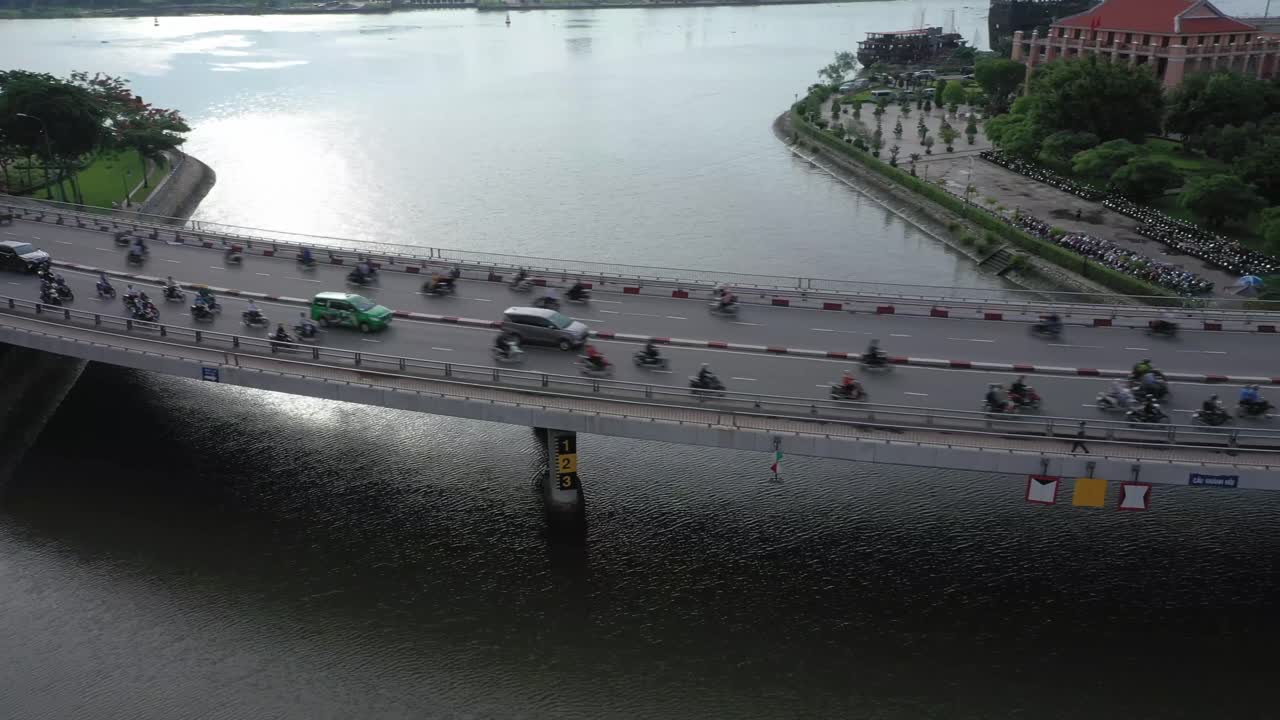 One of 13 drone shots of Khanh Hoi bridge which crosses the Tau Hu canal connecting districts 1 and 4 in Ho Chi Minh City. 4k video in clear morning light with rush hour traffic on this  curved bridge