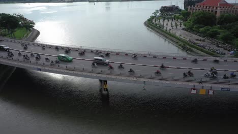one of 13 drone shots of khanh hoi bridge which crosses the tau hu canal connecting districts 1 and 4 in ho chi minh city. 4k video in clear morning light with rush hour traffic on this  curved bridge