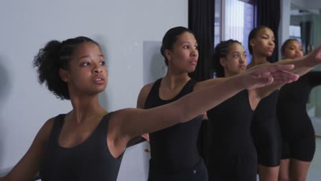 Multi-ethnic-group-of-fit-female-modern-dancers-practicing-a-dance-routine