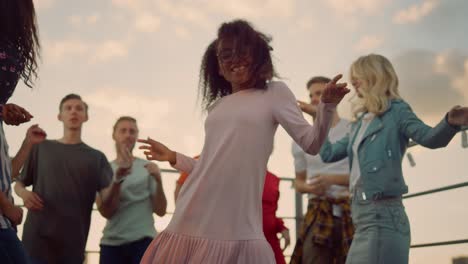 bottom view african american woman dancing for camera at sunset