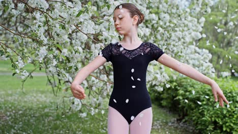 young ballerina in a spring garden