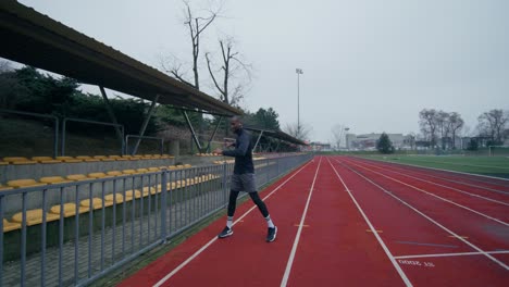 man stretching on a track