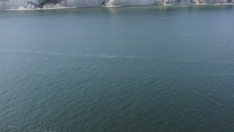 Drone-Aerial-Shot-of-the-chalk-cliffs-on-Ruegen-Rügen-in-Germany-in-beautiful-light-with-green-and-blue-seawater,-Europe