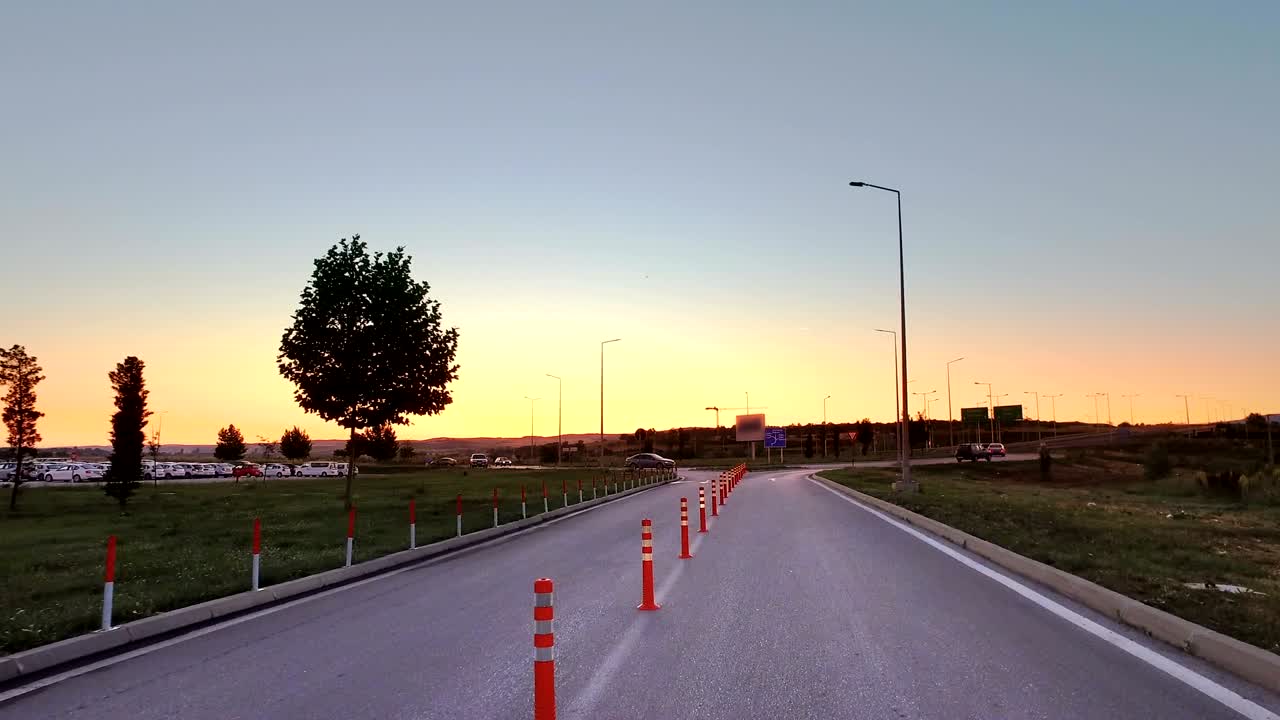 Drive POV on Empty road with Traffic Cones at Dusk With Nice Vibrant Sky