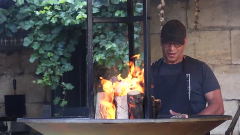 man managing fire in outdoor setting