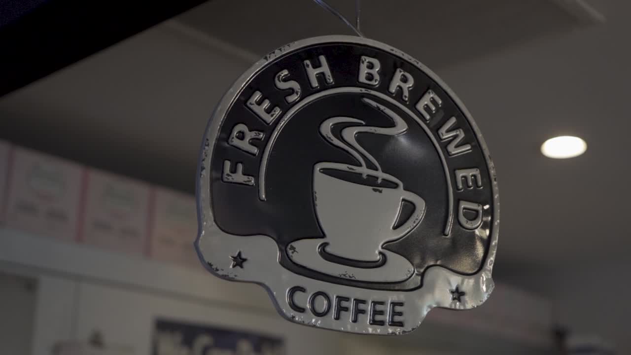 Fresh brewed coffee sign panning in slow motion.