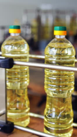 interior of modern natural oil factory. bottling the sunflower oil into plastic container vertical video
