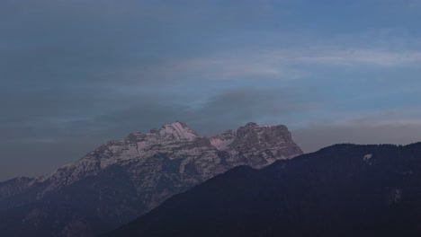 day to night timelapse of alps mountain range and snowy rock in europe