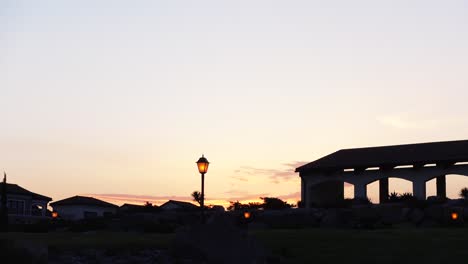 sunset over residential area with gazebo and lamps