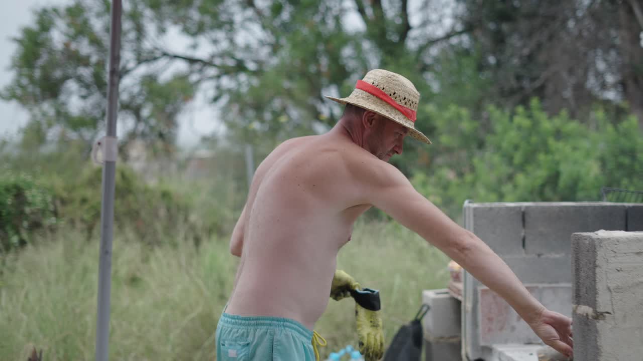 Man tending to an outdoor barbecue or grill