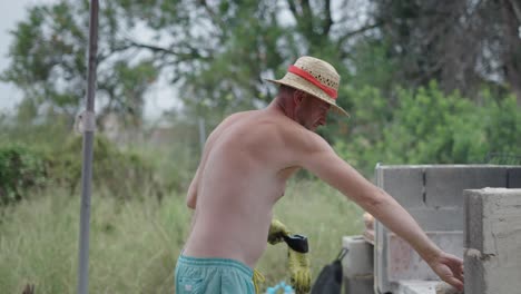 man tending to an outdoor barbecue or grill