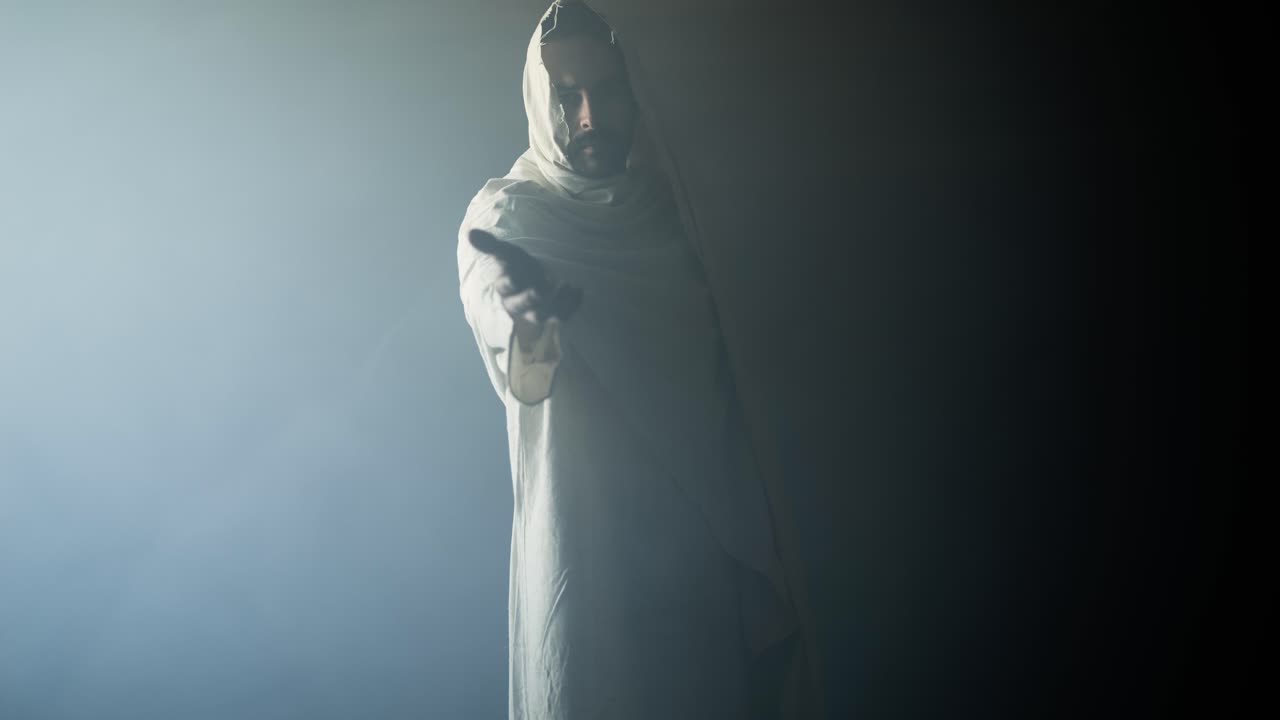 Jesus Christ in glowing, ambient, light offering his hand for salvation, forgiveness. Cinematic visual representation of Easter resurrection, the gospel, and God's love and forgiveness.