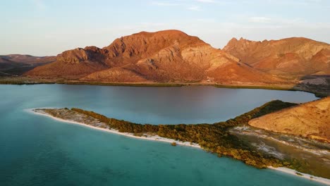 Aerial-view-over-Playa-Balandra-during-majestic-golden-hour-in-the-Baja-California-Sur-desert,-Mexico