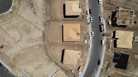 top-down drone footage over spring mountain ranch, riverside, ca, showcasing a patchwork of vacant lots, homes under construction, and completed houses