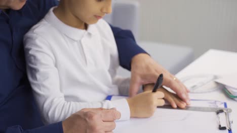 the father is trying to work and play at the same time with the child at home.