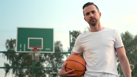 man holding basketball on court