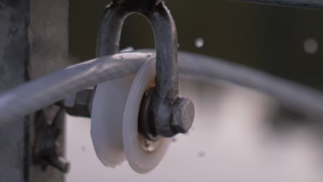 close up blurry mechanism of a rotating spinning wheel with slow motion water drops falling