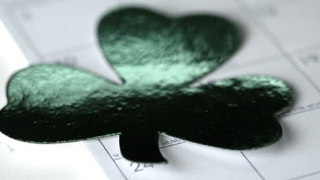 large shamrock falling on calendar marking st patricks day