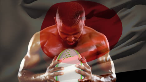 shirtless male rugby player holding ball and screaming