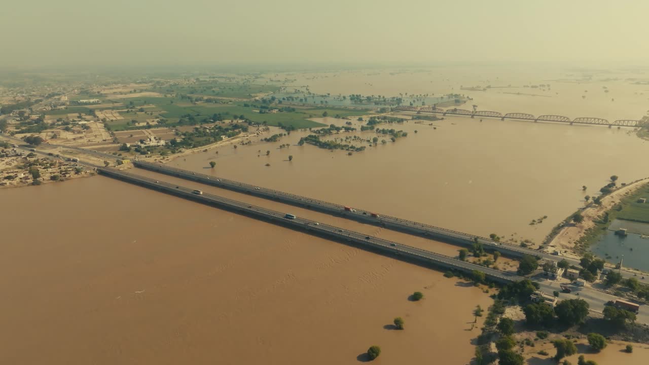 Aerial view of massive flood in River Sutlej at Bahawalpur, Punjab: submerged roads, bridge engineering, inundated landscape, devastation