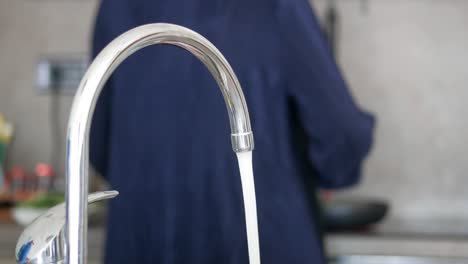 water pouring from a faucet tap slow motion