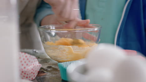 little boy helping mother bake in kitchen mixing ingredients baking cookies preparing recipe at home with mom teaching her son on weekend