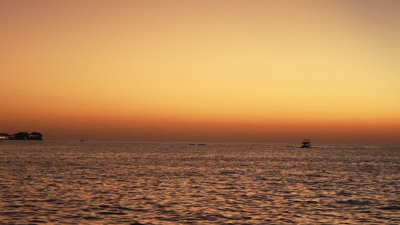 Beautiful stuning sunset,with nice city background,with boat and blue sea