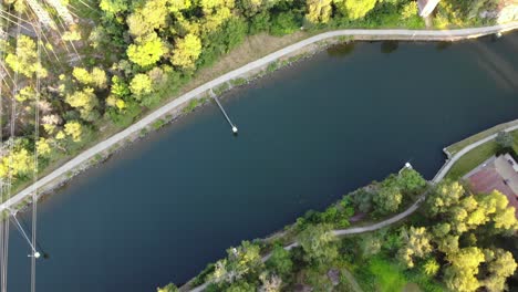 top down aerial flying over göta älv river in town of trollhättan