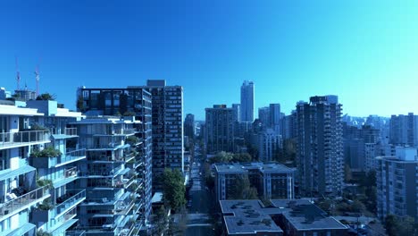 4k drone reveal davie street broughton bute stunning reflective new condo buildings with mirabel marcon rooftop modern outdoor lounge gardens overlooking architectural marvel transformation blue sky