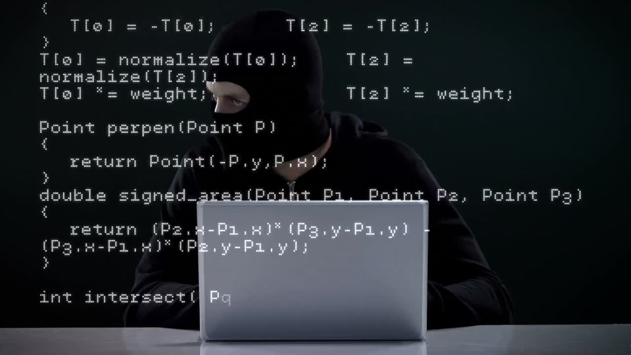 Focused burglar hacking into laptop