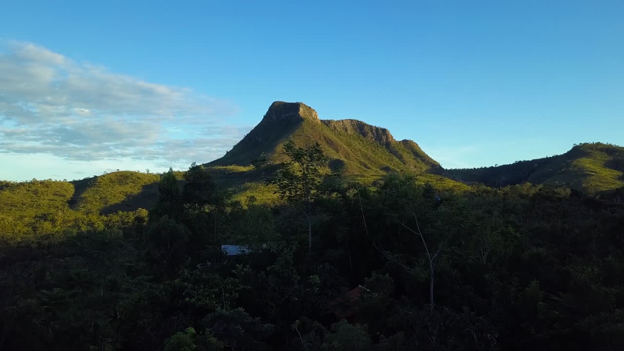 Morning drone shot showcasing a lush green mountain in Chapada dos Veadeiros National Park, Goiás, Brazil