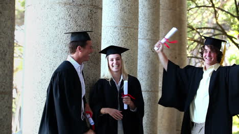 male graduate comes and gives highfive