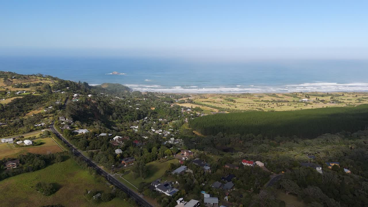 Aerial capture of Muriwai Town and the renowned Muriwai Beach in western Auckland