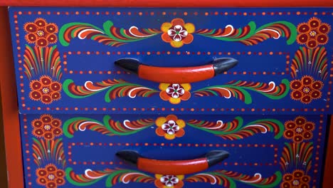 drawer fronts featuring traditional matyó floral designs with red handles
