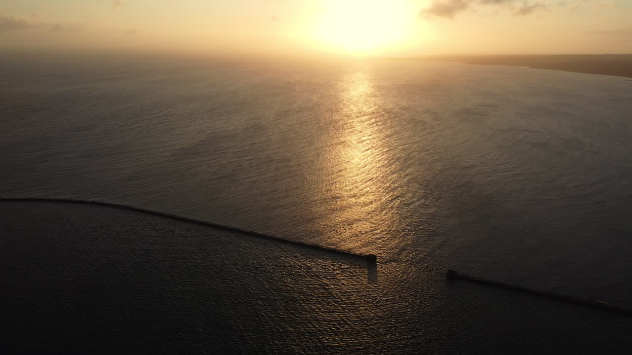 Sunrise over the Ocean with Breakwater