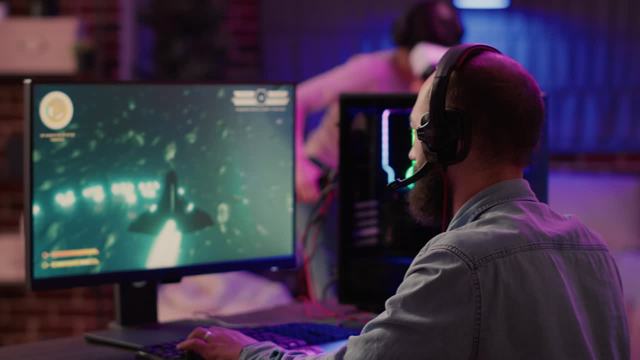 Over shoulder view of gamer playing multiplayer space shooter while gaming girl is fighting in virtual reality